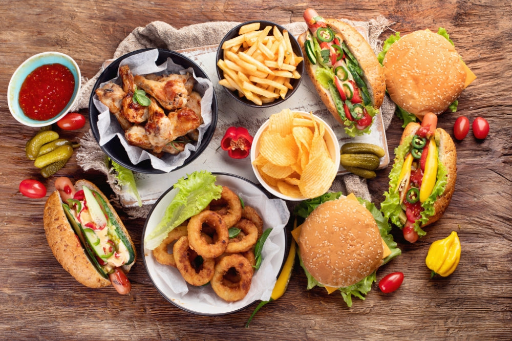 spread of hamburgers, hot dogs, fries, potato chips & picnic food