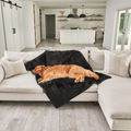 golden retriever dog resting on luxurious black faux fur blanket