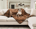 frenchie dog resting on sable tan short fur throw blanket on white couch