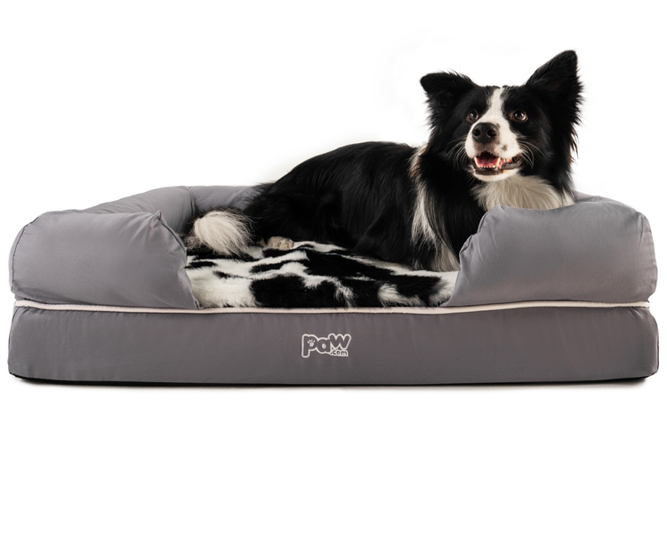 black faux cowhide topper on bolster bed with dog