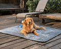 golden retriever laying down on charcoal grey short fur blanket outside